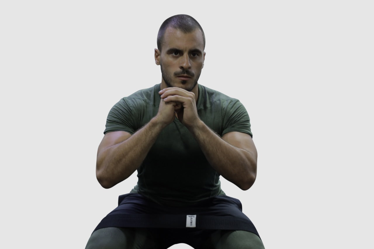 man using black light fabric resistant bands for home workout