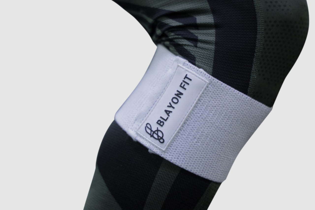 man using white heavy fabric resistant bands for home workout