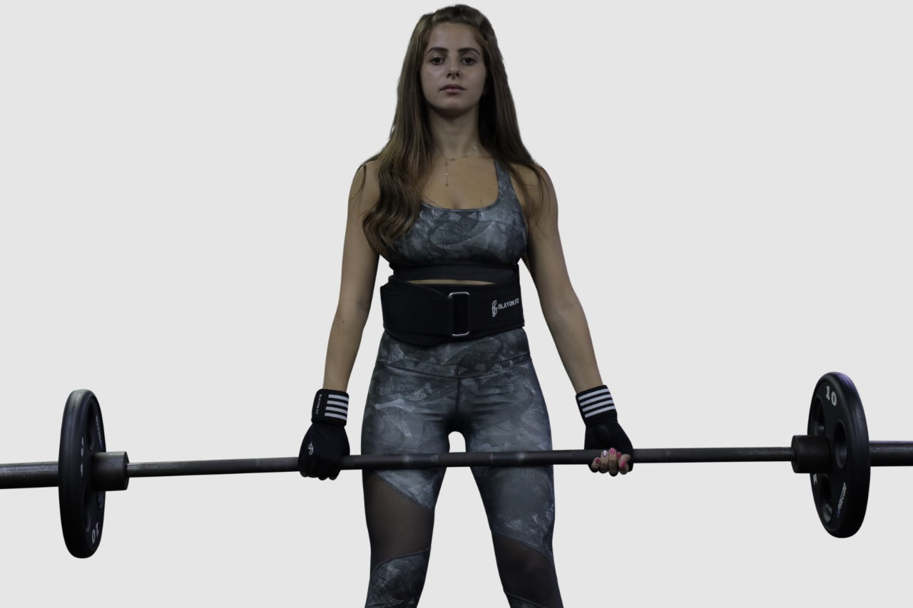 woman using power lifting belt to left in squats and deadlifts