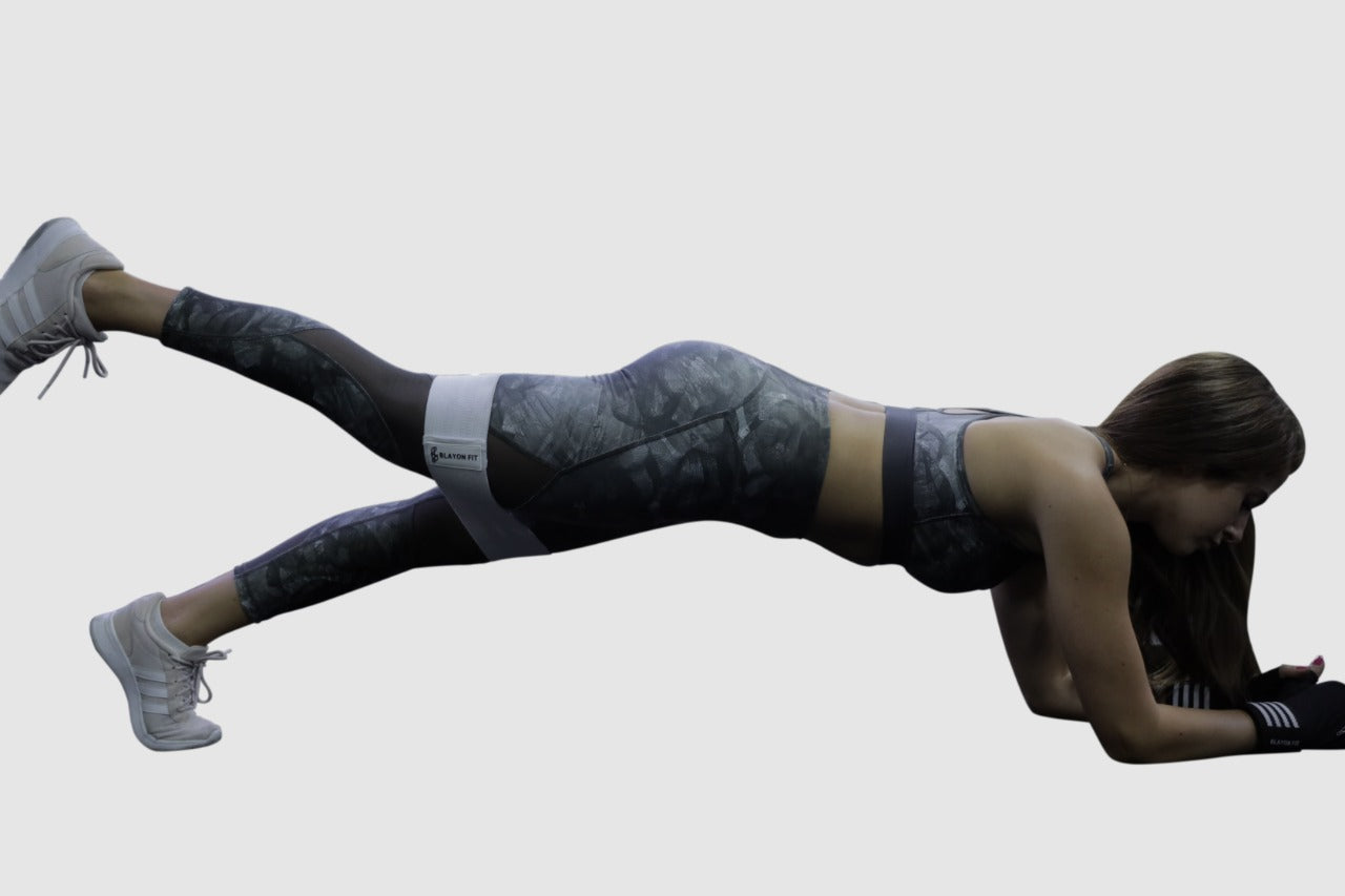 woman using white heavy fabric resistant bands for home workout