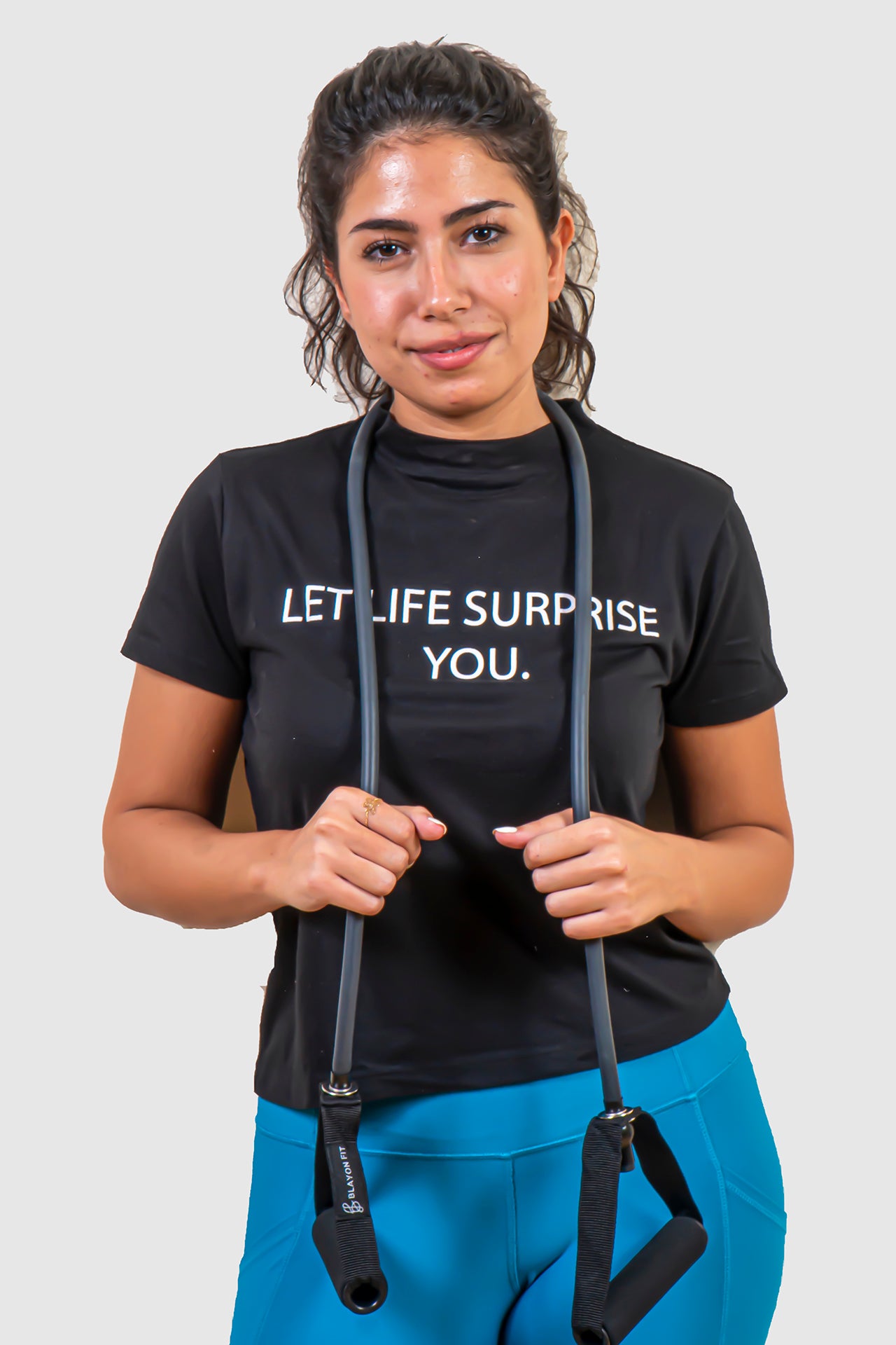 resistant tube is good for toning your muscles. woman holding the resistant band tube.