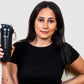 woman holding a protein shaker that is high quality and has a storage for supplements. 