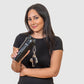 woman holding a protein shaker that is high quality and has a storage for supplements. 