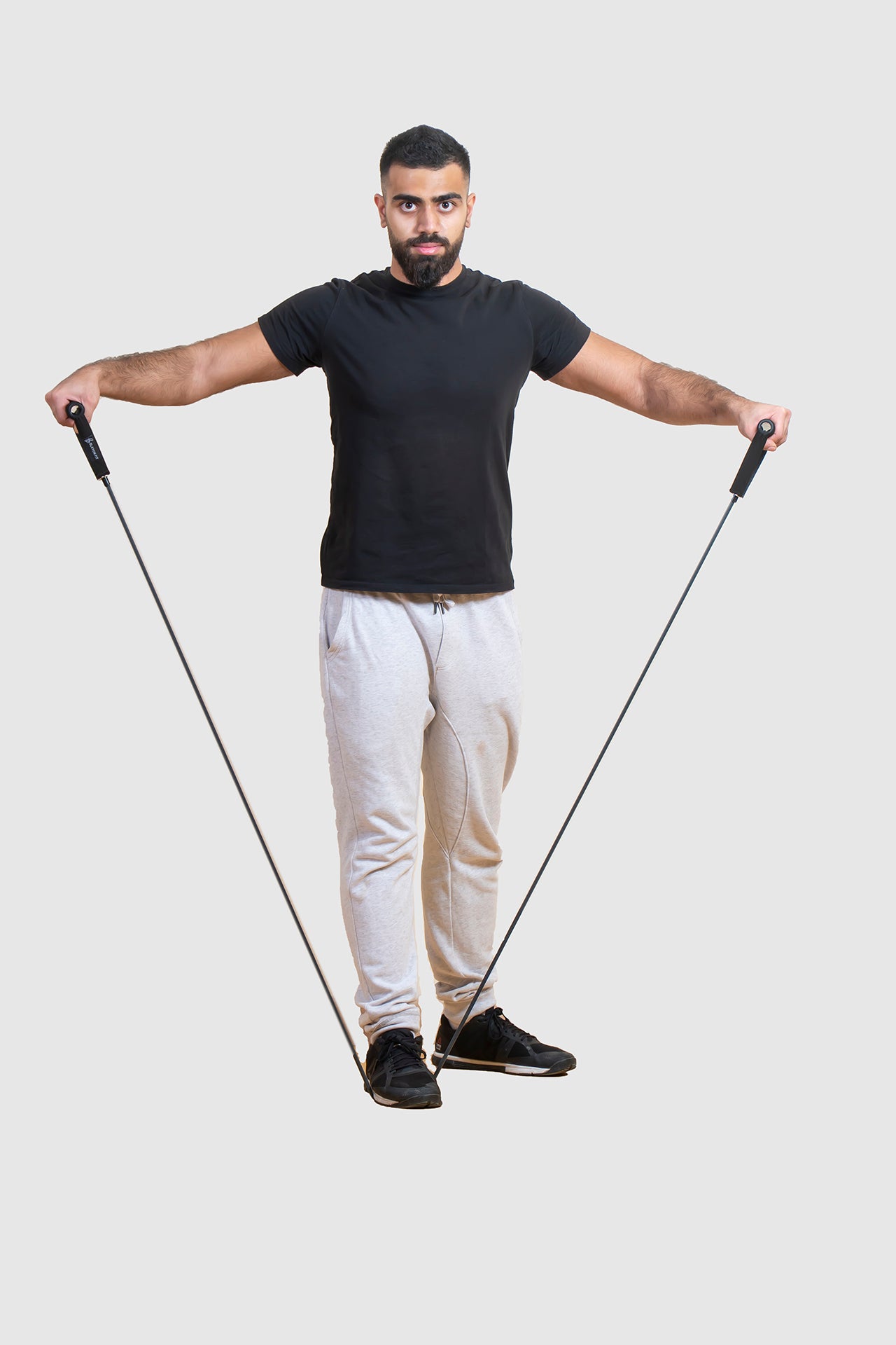man exercising his shoulders  with resistant tube and band.